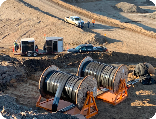 Large flexible hose reels deployed on a mining site for fluid transfer by Prima Pipe Solutions