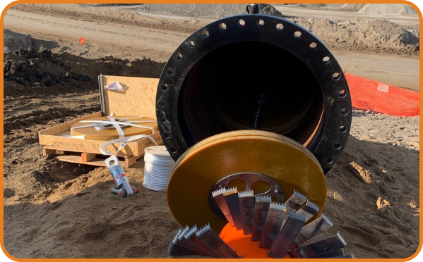 Large diameter pipeline with cutting head and trenchless insertion tools laid out at a construction site by Prima Pipe Solutions